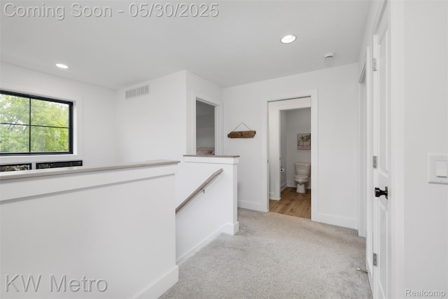 1585 Kriss Crossing Rd, Brighton, MI 48114 - hallway with an upstairs landing, light colored carpet, recessed lighting, and baseboards