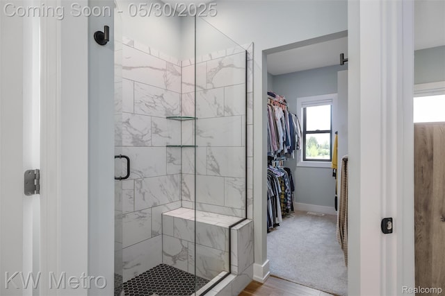 1585 Kriss Crossing Rd, Brighton, MI 48114 - full bath featuring a stall shower, baseboards, a walk in closet, and wood finished floors