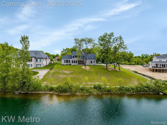 1585 Kriss Crossing Rd, Brighton, MI 48114 - rear view of house featuring a yard and a water view