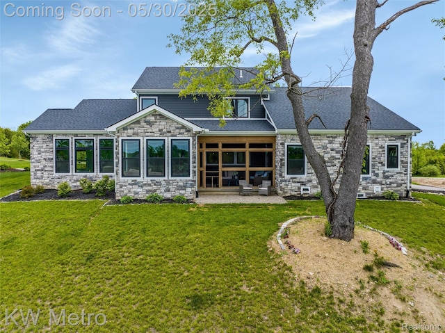 1585 Kriss Crossing Rd, Brighton, MI 48114 - back of property featuring stone siding, a lawn, and a patio area