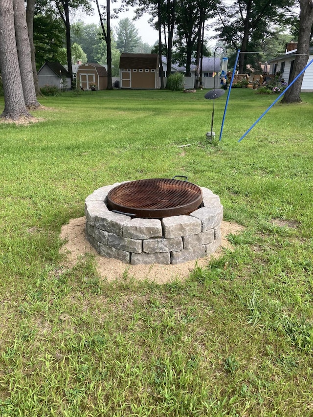 4516 Wah Wah Soo Dr, Gaylord, MI 49735 - view of grassy yard featuring a fire pit