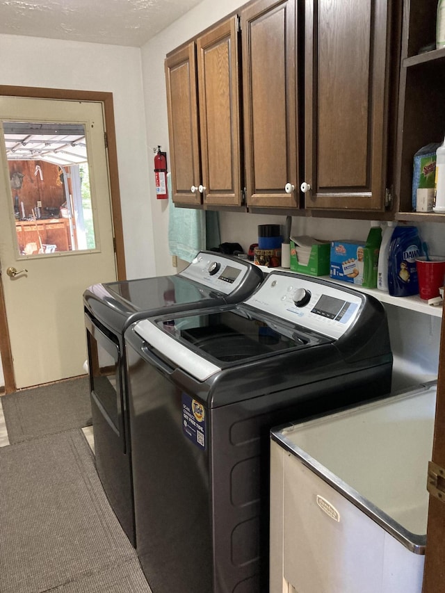4516 Wah Wah Soo Dr, Gaylord, MI 49735 - washroom with washing machine and dryer, cabinet space, and carpet flooring