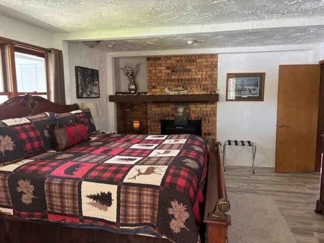 4516 Wah Wah Soo Dr, Gaylord, MI 49735 - bedroom featuring a textured ceiling and wood finished floors
