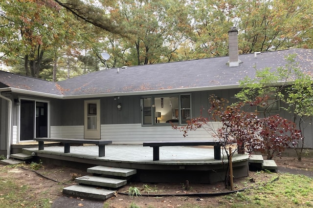 4516 Wah Wah Soo Dr, Gaylord, MI 49735 - back of house with a wooden deck, a chimney, and board and batten siding