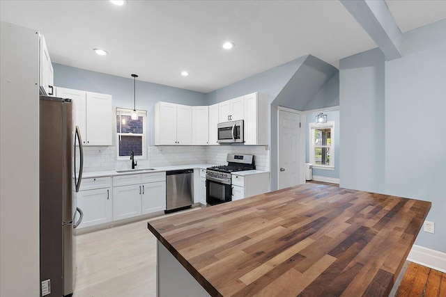 608 Mount Vernon St, Detroit, MI 48202 - kitchen featuring appliances with stainless steel finishes, a sink, light wood-type flooring, decorative backsplash, and recessed lighting