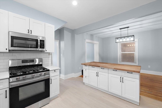 608 Mount Vernon St, Detroit, MI 48202 - kitchen featuring appliances with stainless steel finishes, butcher block counters, baseboards, light wood finished floors, and recessed lighting