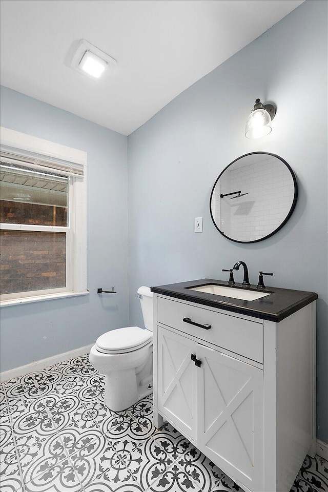 608 Mount Vernon St, Detroit, MI 48202 - half bath with vanity, toilet, baseboards, and tile patterned flooring
