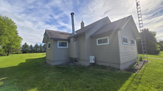 1301 US Highway 10, Scottville, MI 49454 - rear view of house with a chimney and a lawn