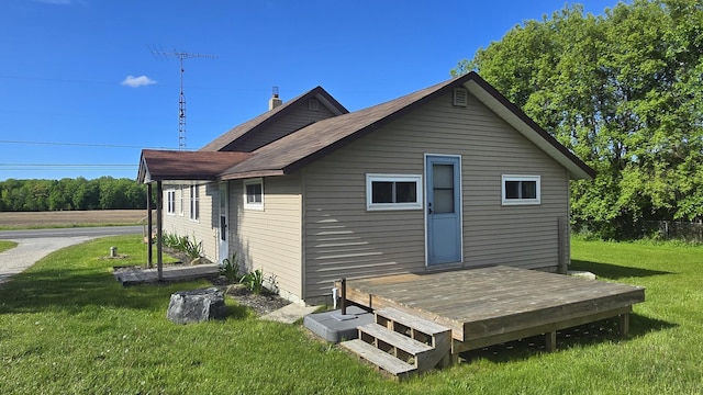 1301 US Highway 10, Scottville, MI 49454 - back of house featuring a deck, a yard, and roof with shingles
