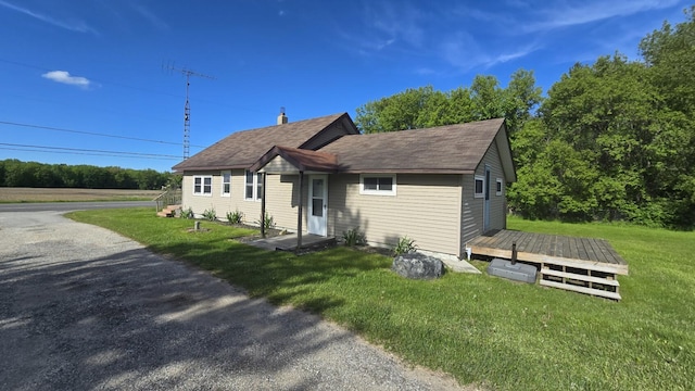 1301 US Highway 10, Scottville, MI 49454 - bungalow-style home featuring a deck, a front lawn, and roof with shingles