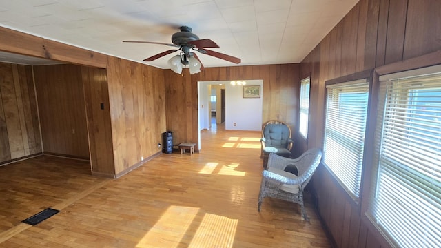 1301 US Highway 10, Scottville, MI 49454 - sitting room with wooden walls, healthy amount of natural light, ceiling fan, and light wood-type flooring