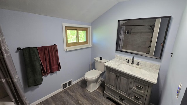 1301 US Highway 10, Scottville, MI 49454 - full bath featuring wood finished floors, vaulted ceiling, toilet, vanity, and baseboards