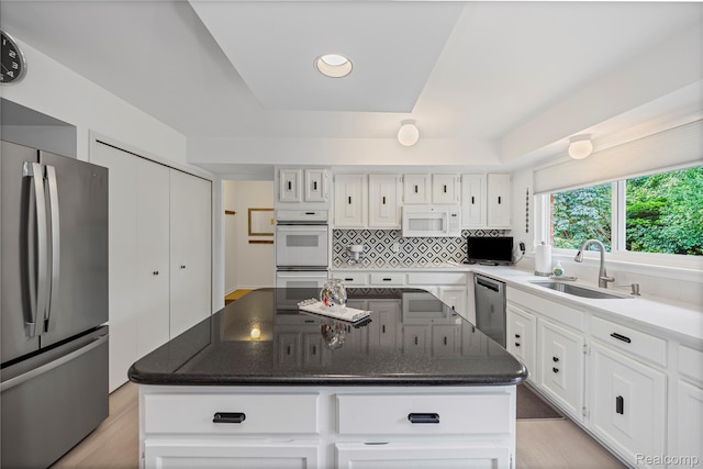 3072 Brewster, West Bloomfield, MI 48322 - kitchen with appliances with stainless steel finishes, a center island, white cabinetry, tasteful backsplash, and recessed lighting
