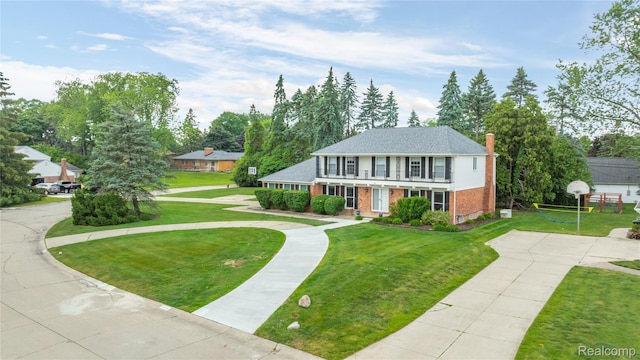3072 Brewster, West Bloomfield, MI 48322 - view of front of home with a balcony, brick siding, and a front yard