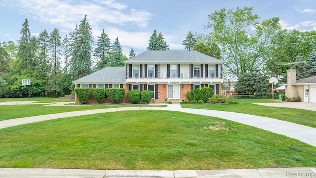 3072 Brewster, West Bloomfield, MI 48322 - view of front of home with a balcony, a front yard, brick siding, and driveway