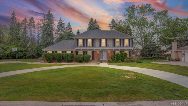 3072 Brewster, West Bloomfield, MI 48322 - colonial inspired home featuring a front lawn, curved driveway, and brick siding