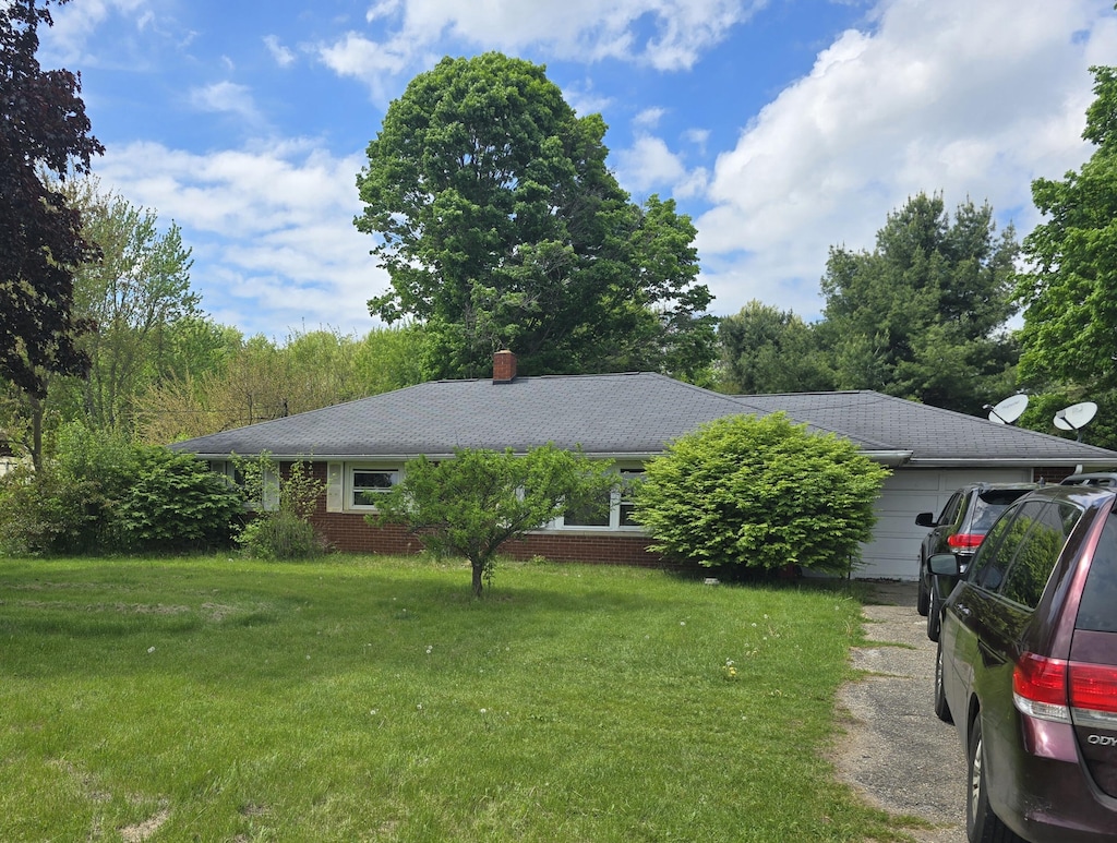 16783 E Augusta Dr, Augusta, MI 49012 - view of front of home with a front lawn, brick siding, and a chimney