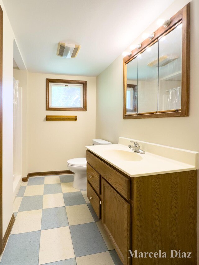 9555 Eastern Ave SE, Byron Center, MI 49315 - bathroom featuring tile patterned floors, vanity, toilet, baseboards, and a shower