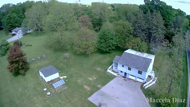 9555 Eastern Ave SE, Byron Center, MI 49315 - aerial view of property and surrounding area featuring a heavily wooded area
