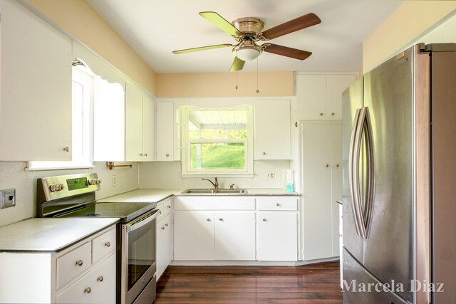 9555 Eastern Ave SE, Byron Center, MI 49315 - kitchen with stainless steel appliances, a sink, light countertops, ceiling fan, and dark wood-style floors