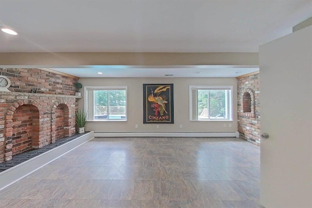 16172 Crest Dr, Linden, MI 48451 - unfurnished living room featuring plenty of natural light, a fireplace, baseboard heating, brick wall, and baseboards