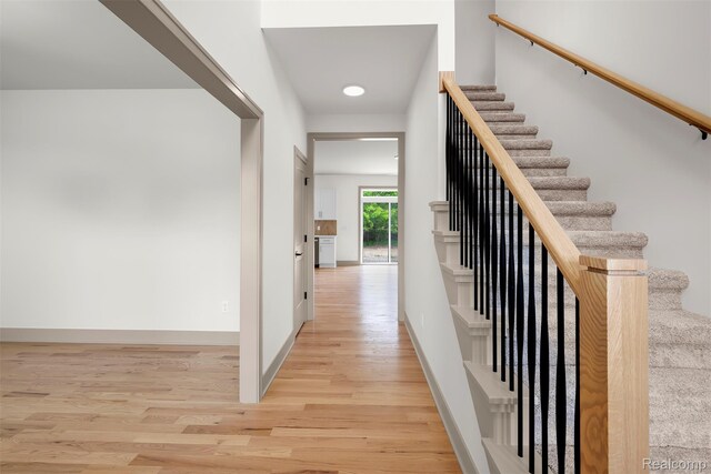 3097 Gecko Trl, Pinckney, MI 48169 - hall with wood finished floors, baseboards, and stairs