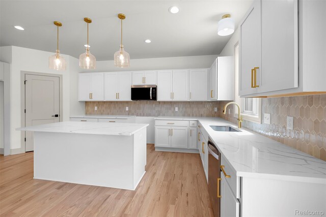 3097 Gecko Trl, Pinckney, MI 48169 - kitchen with stainless steel appliances, a sink, light wood-style flooring, white cabinetry, and light stone counters