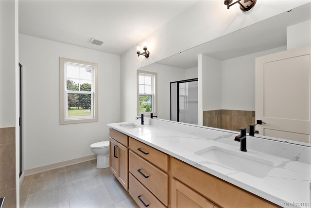 3097 Gecko Trl, Pinckney, MI 48169 - full bathroom featuring double vanity, a shower stall, baseboards, toilet, and tile patterned floors