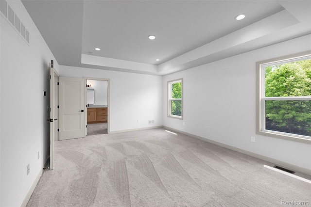 3097 Gecko Trl, Pinckney, MI 48169 - unfurnished bedroom with a tray ceiling, light colored carpet, recessed lighting, and baseboards