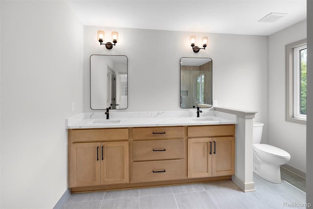 3097 Gecko Trl, Pinckney, MI 48169 - full bath with double vanity, toilet, baseboards, and tile patterned floors