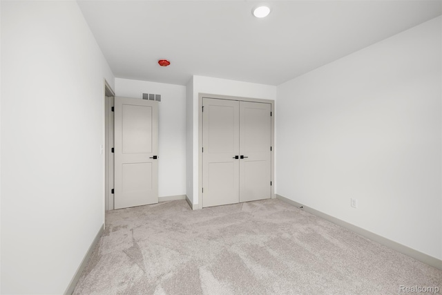 3097 Gecko Trl, Pinckney, MI 48169 - unfurnished bedroom with light colored carpet, baseboards, and a closet