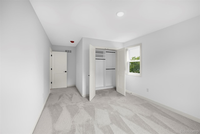 3097 Gecko Trl, Pinckney, MI 48169 - unfurnished bedroom featuring light carpet, baseboards, and a closet