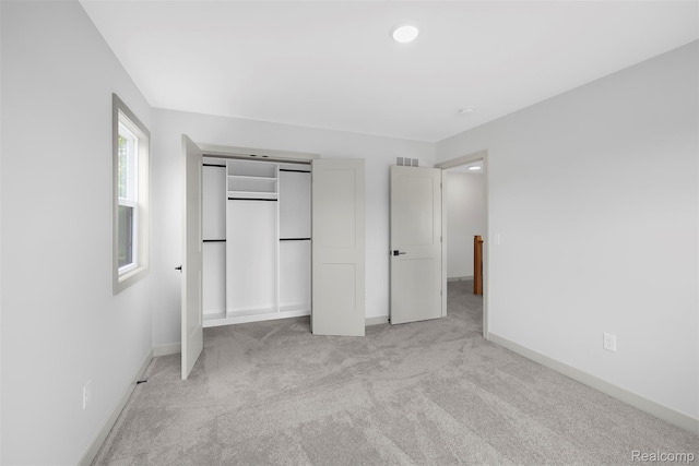 3097 Gecko Trl, Pinckney, MI 48169 - unfurnished bedroom featuring light colored carpet, baseboards, and a closet