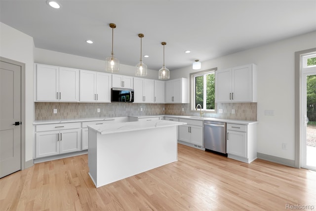 3097 Gecko Trl, Pinckney, MI 48169 - kitchen featuring appliances with stainless steel finishes, decorative backsplash, light wood-style flooring, white cabinetry, and recessed lighting
