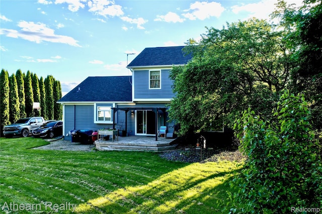 16429 E Horseshoe Trl, Linden, MI 48451 - rear view of house with a shingled roof, a yard, and a deck