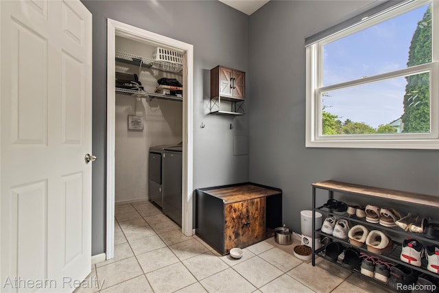 16429 E Horseshoe Trl, Linden, MI 48451 - laundry area featuring washer and dryer and light tile patterned floors