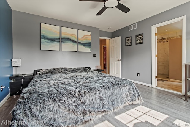 16429 E Horseshoe Trl, Linden, MI 48451 - bedroom with wood finished floors, a ceiling fan, and connected bathroom