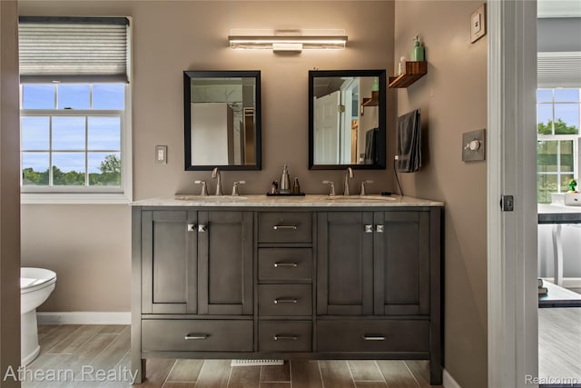 16429 E Horseshoe Trl, Linden, MI 48451 - full bathroom with wood tiled floors, plenty of natural light, and double vanity
