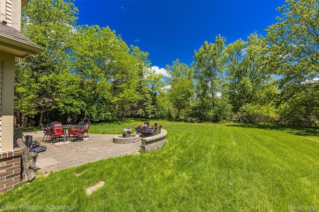42900 Ledgeview Dr, Novi, MI 48377 - view of green lawn featuring a patio area and an outdoor fire pit