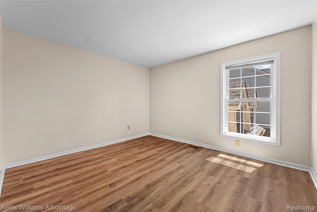 42900 Ledgeview Dr, Novi, MI 48377 - empty room featuring wood finished floors and baseboards