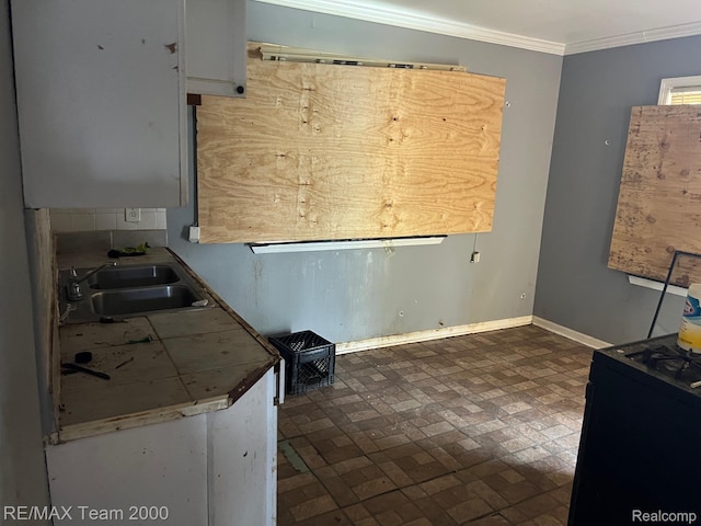 8505 Heyden St, Detroit, MI 48228 - kitchen featuring a sink, brick patterned floors, black range, ornamental molding, and baseboards