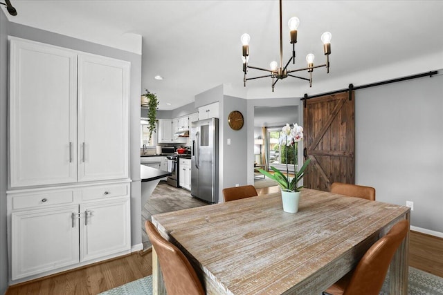 30139 Bentley St, Livonia, MI 48154 - dining room featuring a barn door, dark wood finished floors, a chandelier, healthy amount of natural light, and recessed lighting