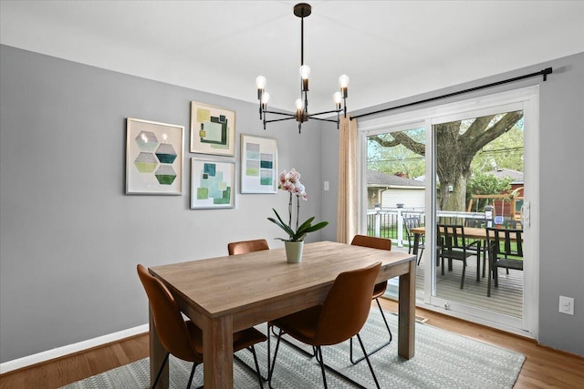 30139 Bentley St, Livonia, MI 48154 - dining room with a chandelier, wood finished floors, and baseboards