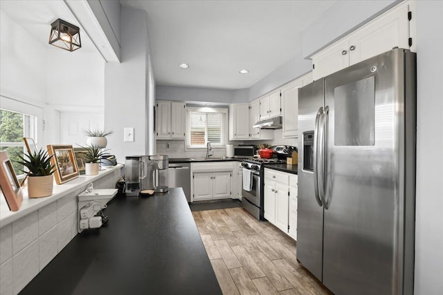 30139 Bentley St, Livonia, MI 48154 - kitchen featuring stainless steel appliances, under cabinet range hood, white cabinets, light wood-style flooring, and recessed lighting