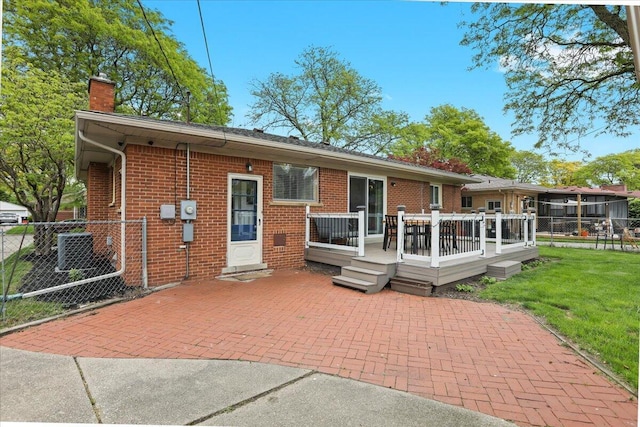 30139 Bentley St, Livonia, MI 48154 - rear view of property with a chimney, brick siding, a deck, and a patio