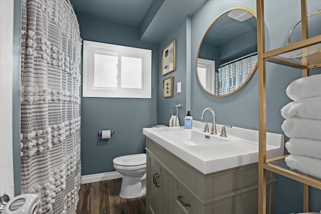 30139 Bentley St, Livonia, MI 48154 - bathroom with vanity, toilet, wood finished floors, baseboards, and a shower with curtain