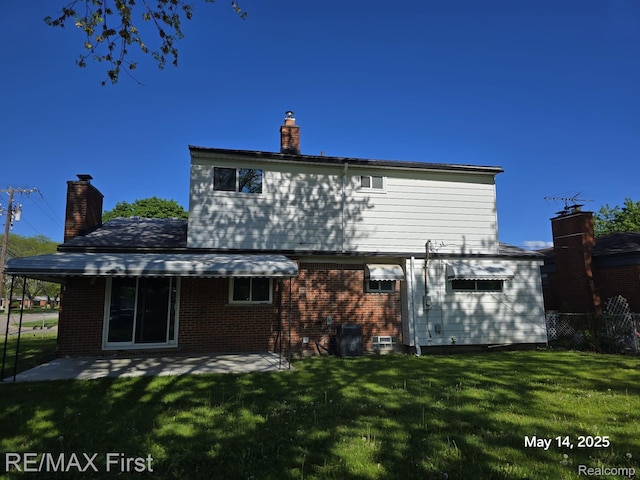 31859 Shawn Dr, Warren, MI 48088 - rear view of property featuring a chimney, brick siding, a patio, and central AC unit