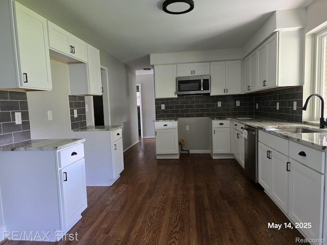 31859 Shawn Dr, Warren, MI 48088 - kitchen with stainless steel appliances, a sink, decorative backsplash, light stone countertops, and dark wood-style floors