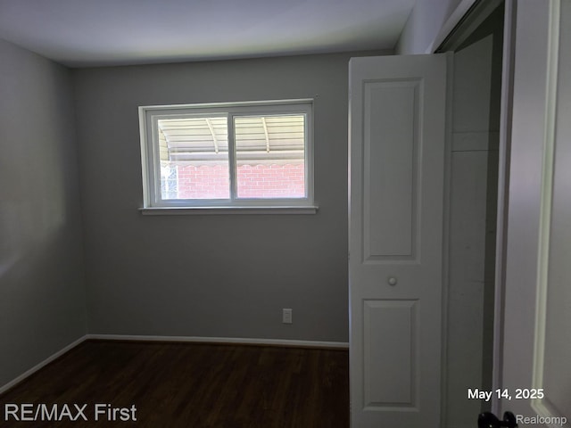 31859 Shawn Dr, Warren, MI 48088 - unfurnished bedroom featuring dark wood-type flooring and baseboards