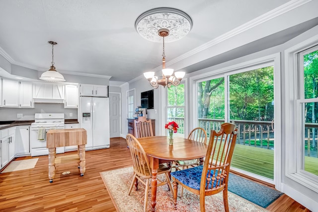 9180 Dicey St, Montague, MI 49437 - dining room with light wood-style floors, a chandelier, and ornamental molding
